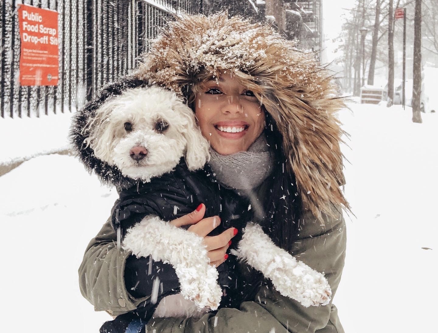 Naty with her dog, Kiko, in the snow in Hell's Kitchen.