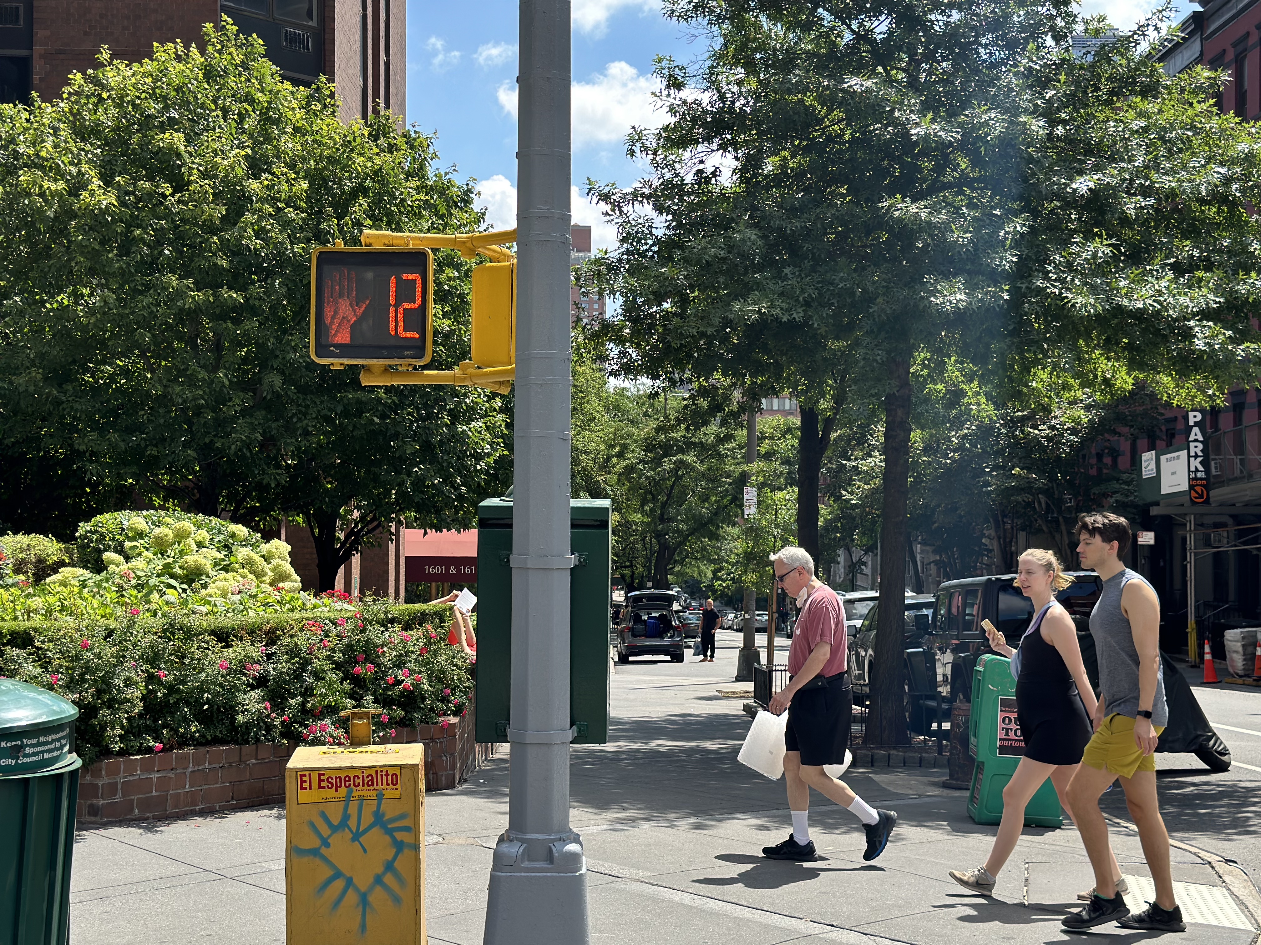 Crosswalk signs with the hand or walker were along E90th Street.