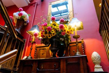 Flowers on the stairs at Kings' Carriage House. British Tea Shops Upper East Side Yorkville