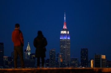 The Empire State Building is lit in the colors of Great Britain for the arrival of the Duke and Duchess of Cambridge in New York, December 7, 2014.  Headquarters and Offices Historic Site Tourist Attractions Visitor Centers Chelsea Garment District Koreatown Tenderloin
